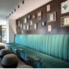 Bancada tapizada verde con respaldo canalé para lobby o bar
